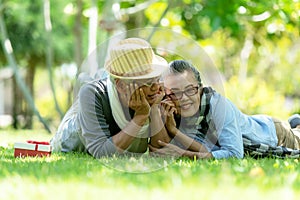 Asian Lifestyle senior couple surprise gift for special day  in the nature park happy and relax time.Â 